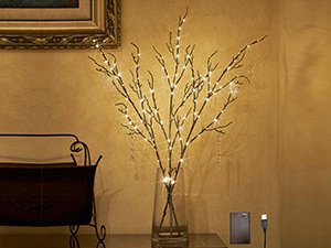 Brown twig garland with 120 LED fairy lights in a glass vase, indoors.