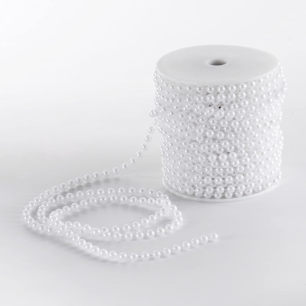 Spool of white faux pearl garland strand on a white background