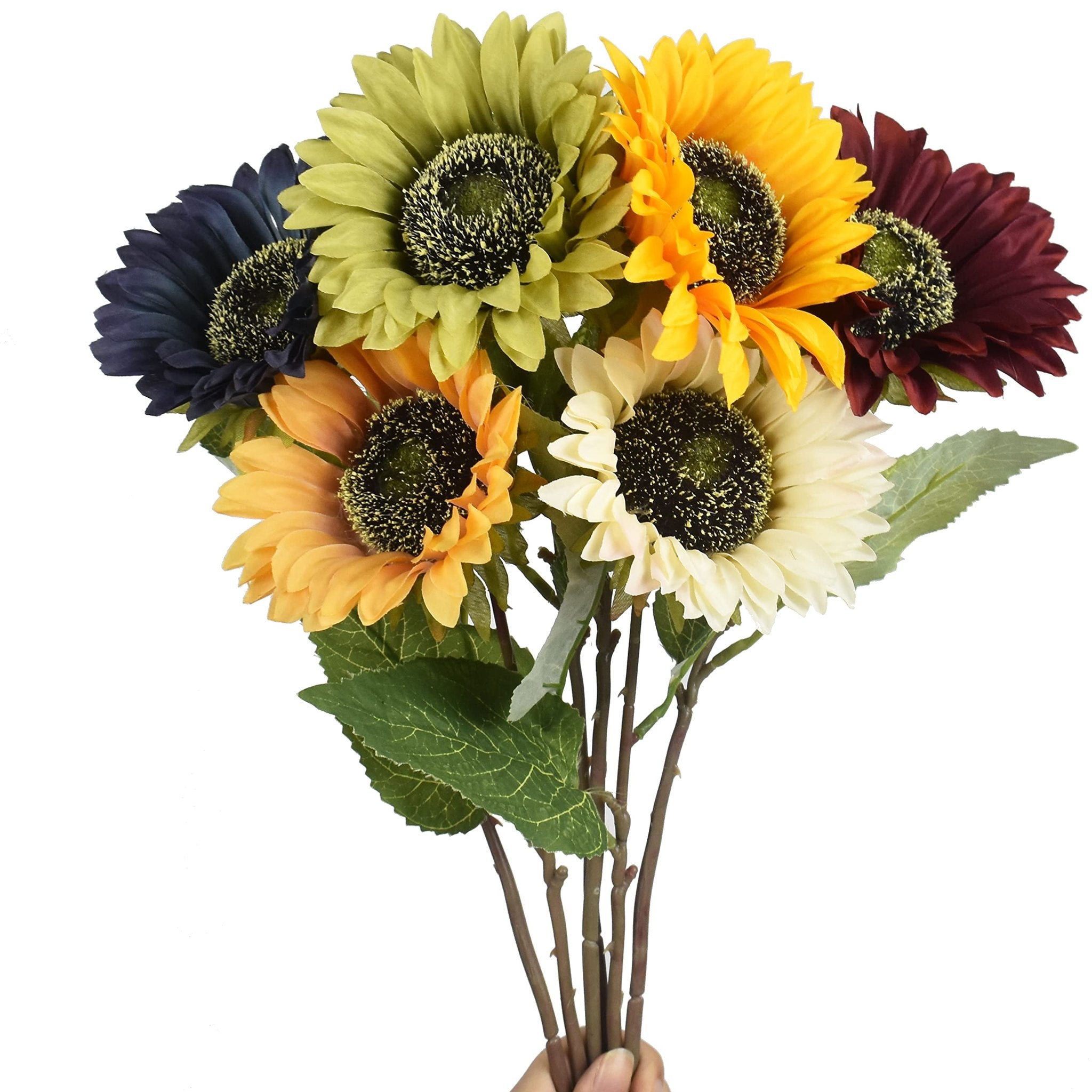 Bouquet of six artificial sunflowers in various colors including yellow, cream, burgundy, green, and navy, held by a hand against a white background.