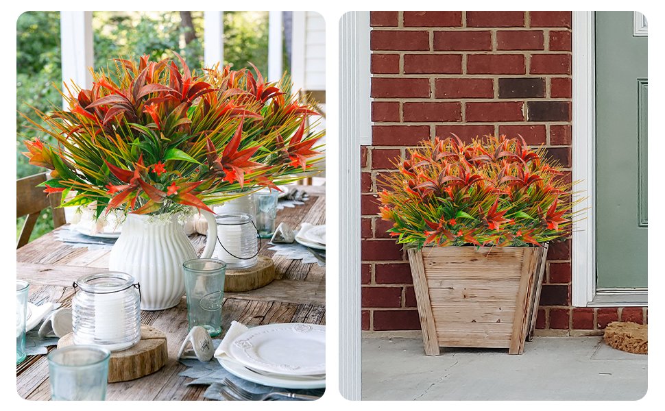 Artificial orange and red morning glory flowers with green foliage arranged in a vase on a table and in a planter by a door.