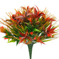 Artificial plant with red and green leaves and small orange flowers, on a white background.