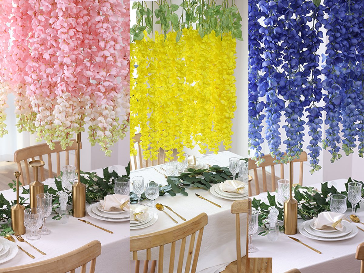 Three different colors of artificial wisteria hanging flowers draped over tables set for a meal.