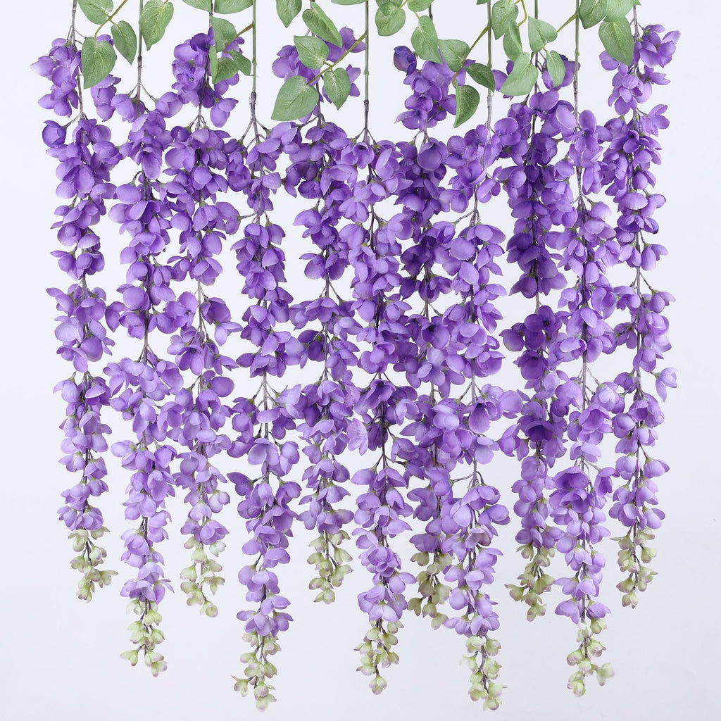 Six strands of artificial purple wisteria flowers with green leaves hanging against a white background.