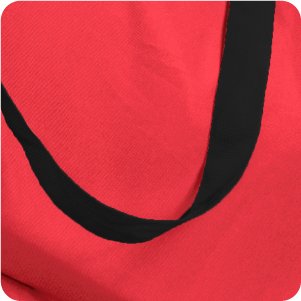 Close-up of a red Christmas tree storage bag with a black handle strap.