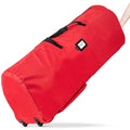 Red artificial Christmas tree storage bag with wheels and handles, shown at an angle with a hand pulling the handle.