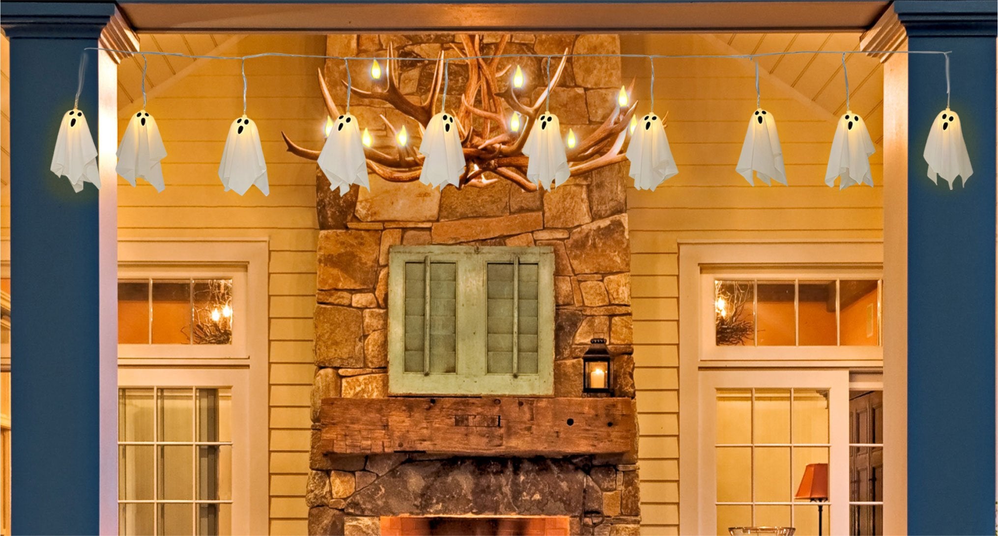 Ghost string lights with 10 LED ghosts hanging on a house exterior at dusk