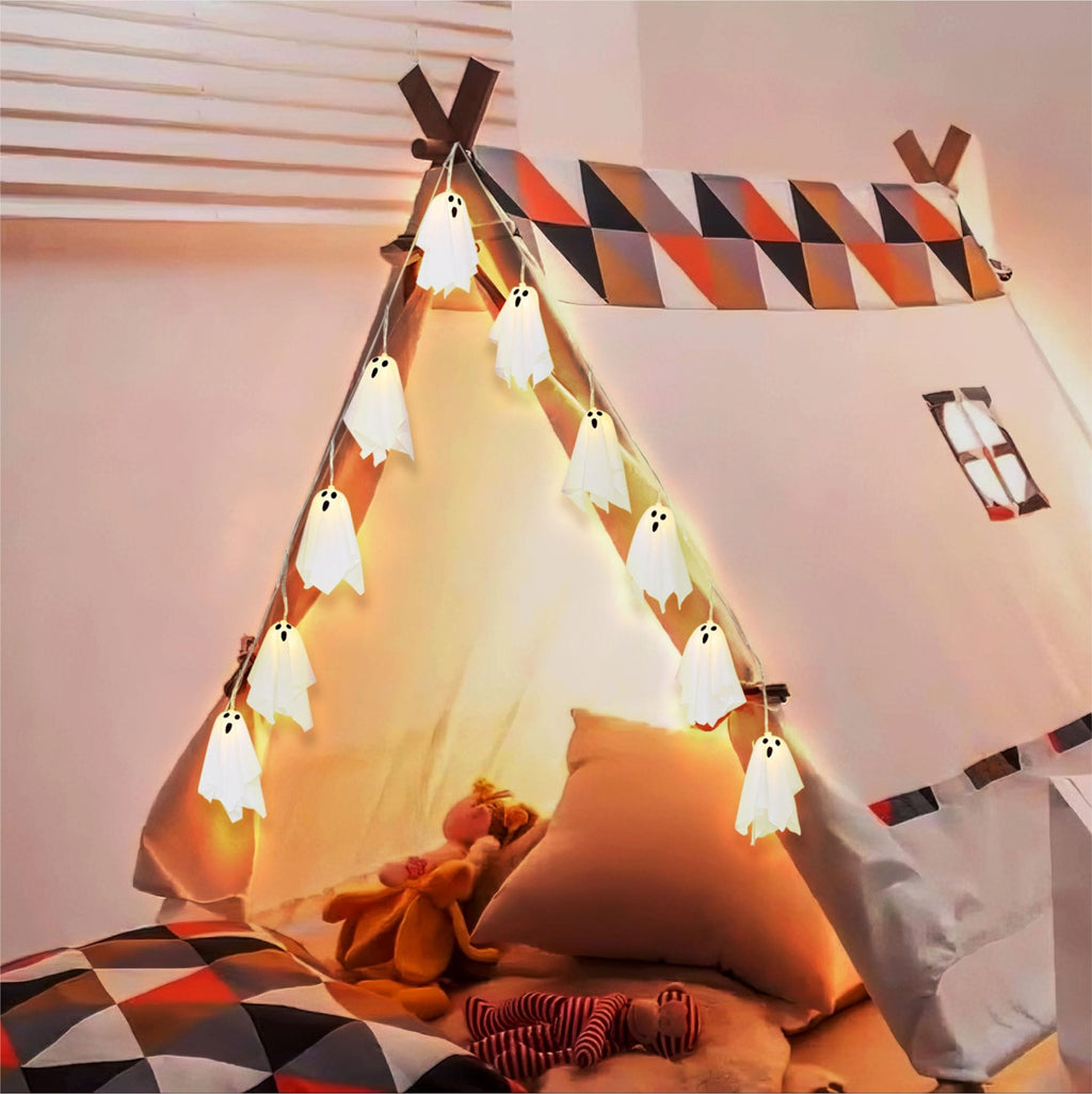 String lights with 10 white ghost-shaped LEDs draped inside a teepee tent with stuffed animals.