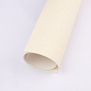 Rolled up beige textured canvas on a white background, showing the edge and underside of the roll.