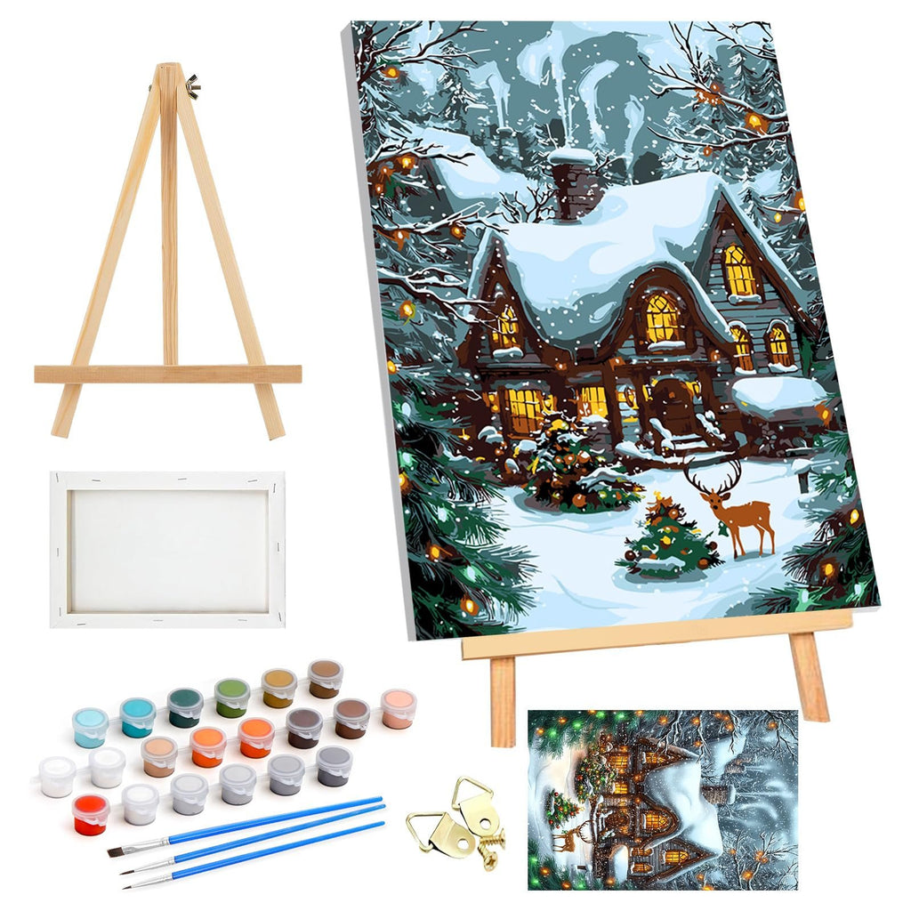 Christmas paint by numbers kit contents including canvas, paints, brushes, easel, and framed artwork of a snowy house with a deer.