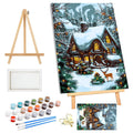 Christmas paint by numbers kit contents including canvas, paints, brushes, easel, and framed artwork of a snowy house with a deer.