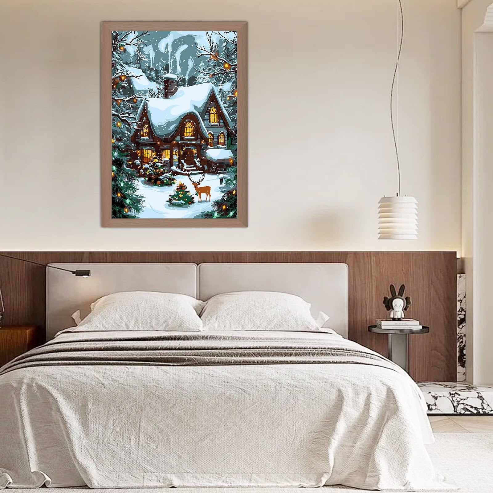 Framed paint by numbers kit showing a snowy cottage scene with a deer and Christmas trees