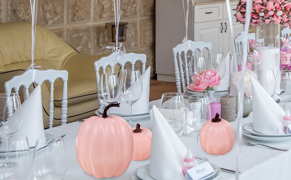 Assorted light pink foam pumpkins with resin stems arranged on a decorated table setting.