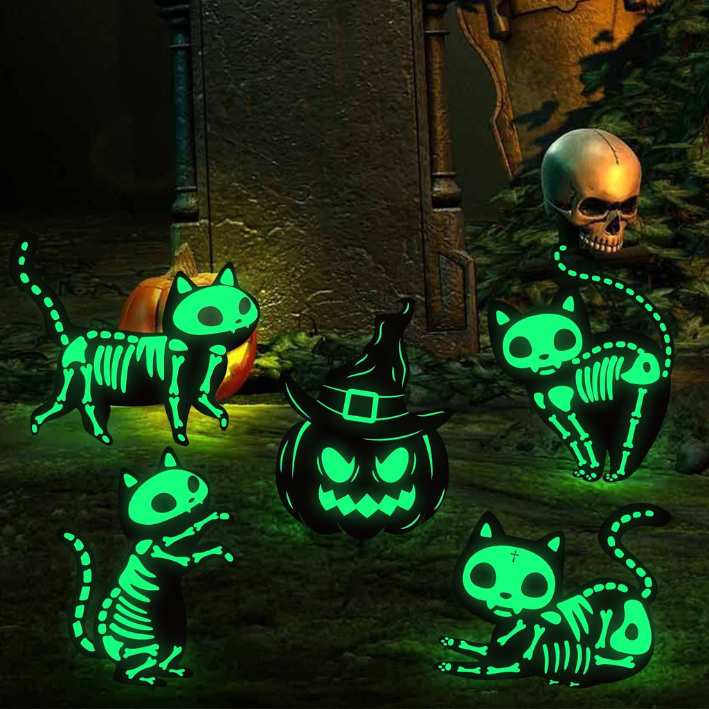 Glow-in-the-dark Halloween yard signs featuring skeleton cats and a pumpkin with a witch hat, set against a spooky graveyard background.