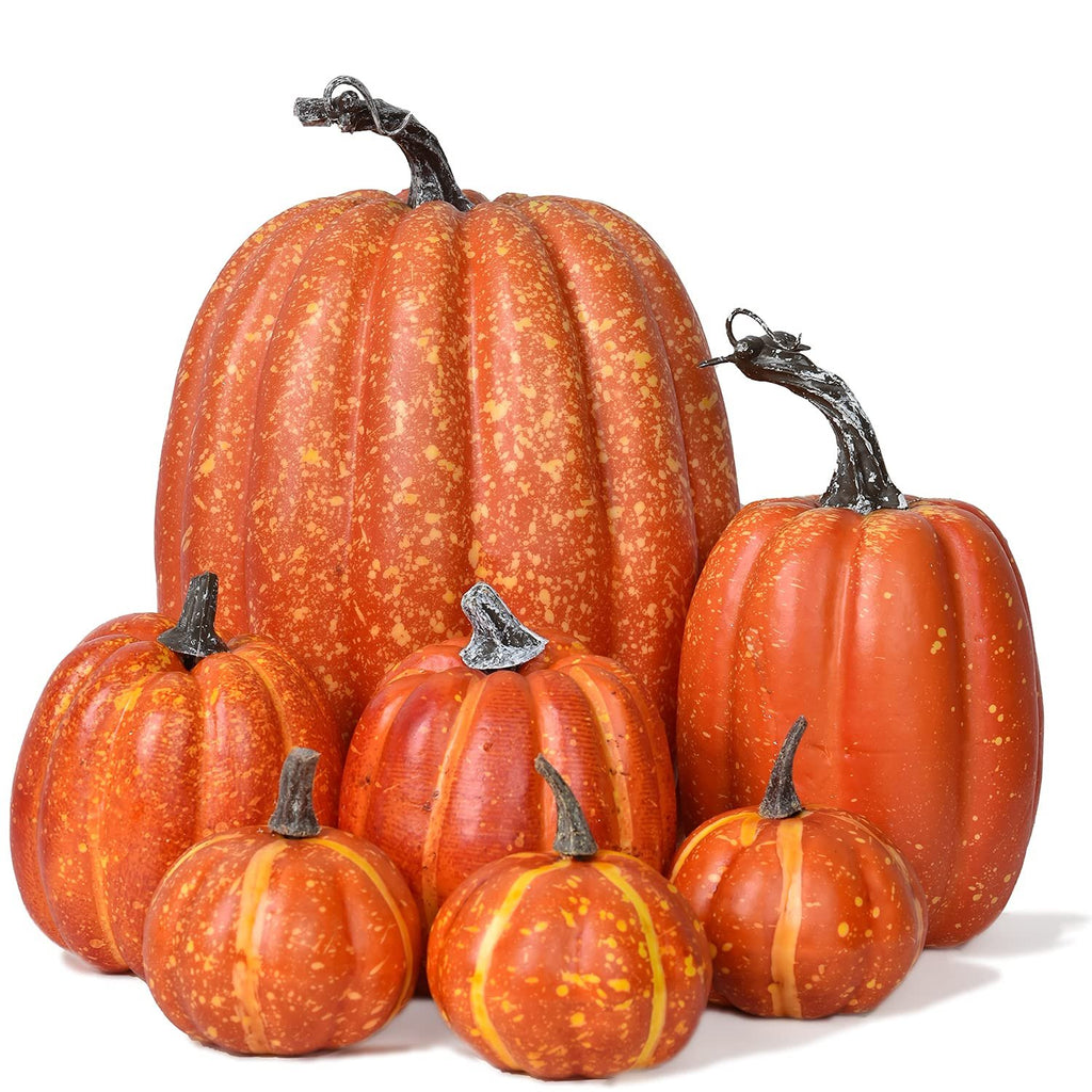 Set of six artificial orange pumpkins with speckled yellow accents and dark stems, arranged on a white background.