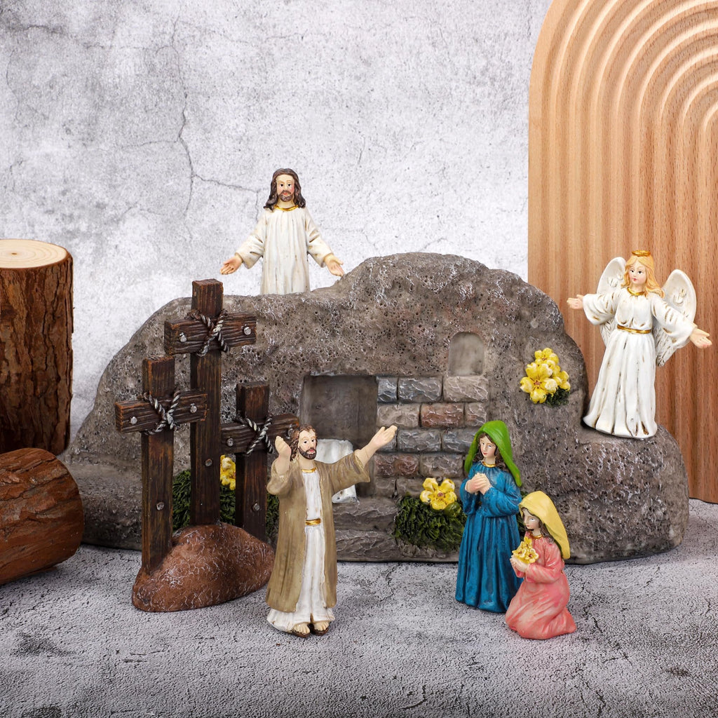 Easter Resurrection Scene with Jesus, angel, and women figurines around a tomb and crosses.