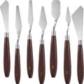 Seven palette knives with stainless steel blades and dark wood handles, numbered 1 through 5, displayed against a white background.