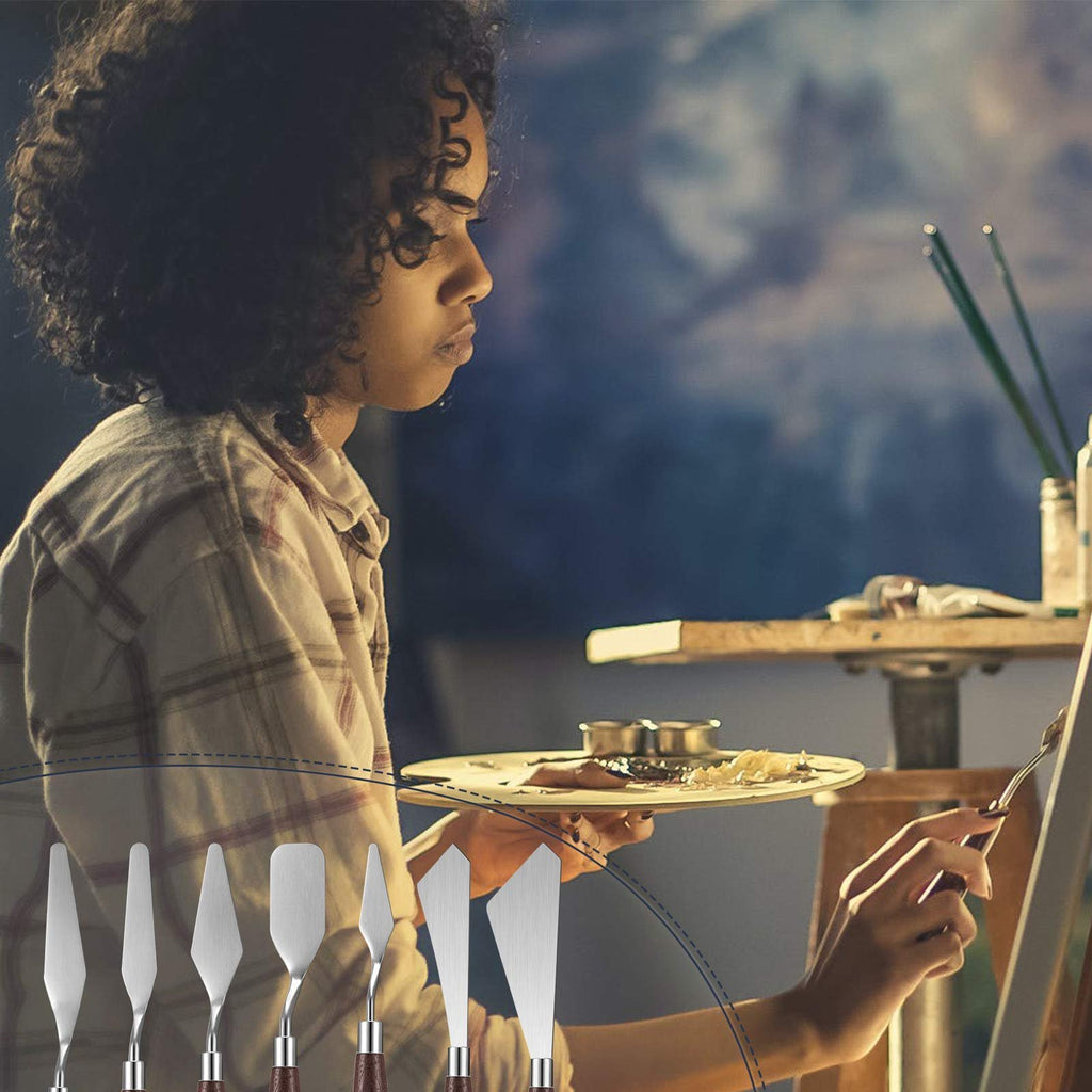 Artist painting with palette knives and paint on a palette, set of 7 knives displayed