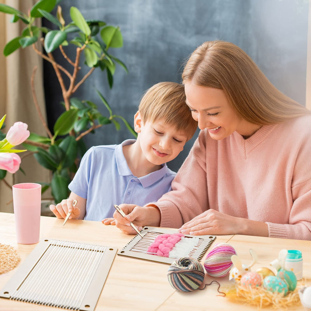 Mother and son weaving on a wooden loom kit, with yarn and Easter decorations on the table.