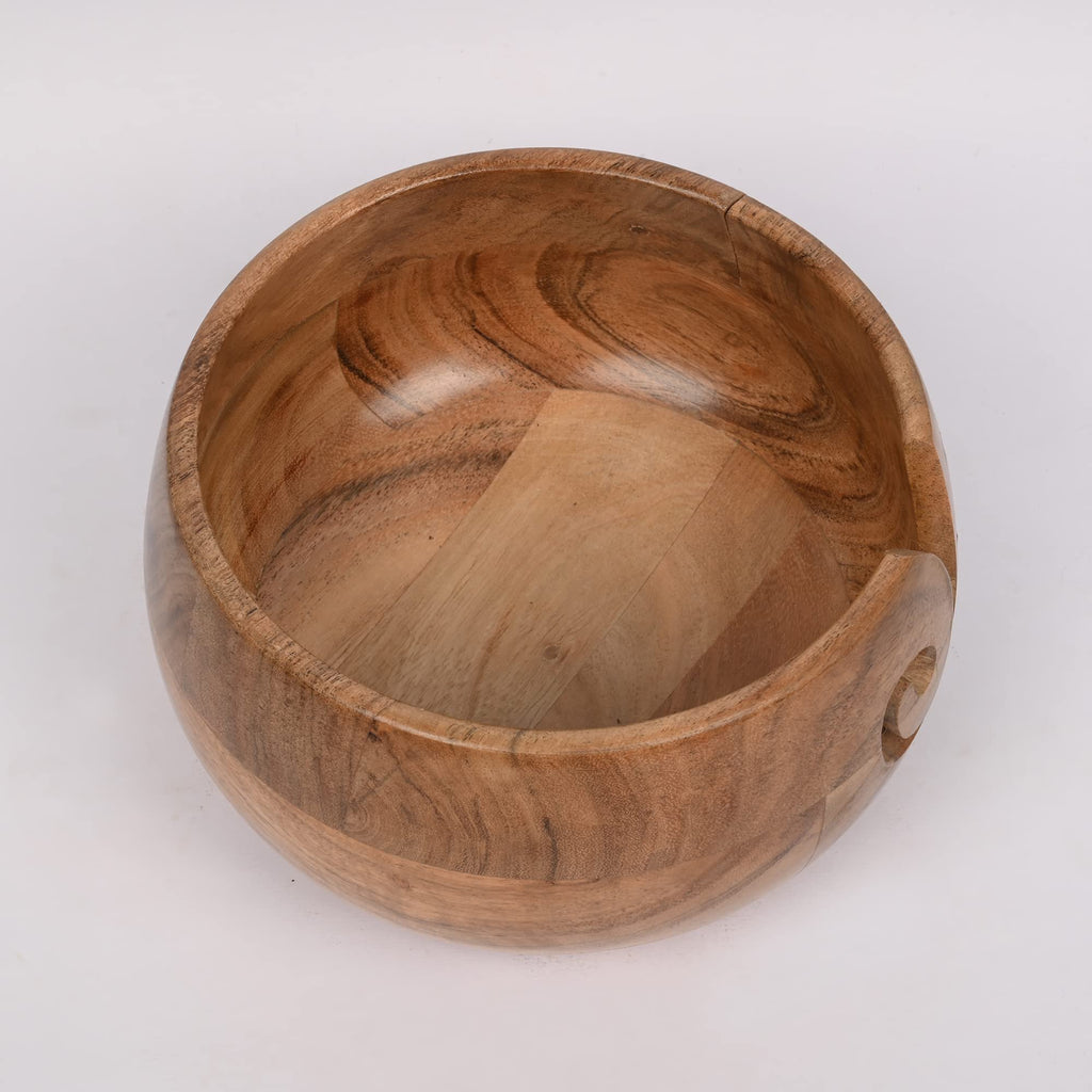 Acacia wood yarn bowl with side holes for yarn, shown from a slightly elevated angle on a white background.
