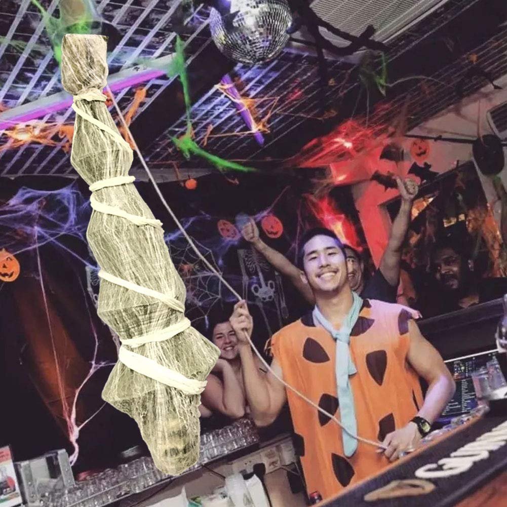 Hanging skeleton prop with spider web decoration in a party setting with people in costumes