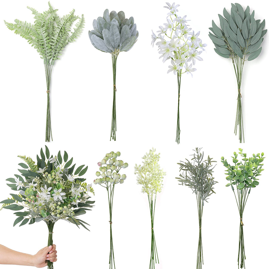 Assortment of artificial greenery stems including fern, lamb's ear, eucalyptus, and rosemary, with a hand holding one bouquet.