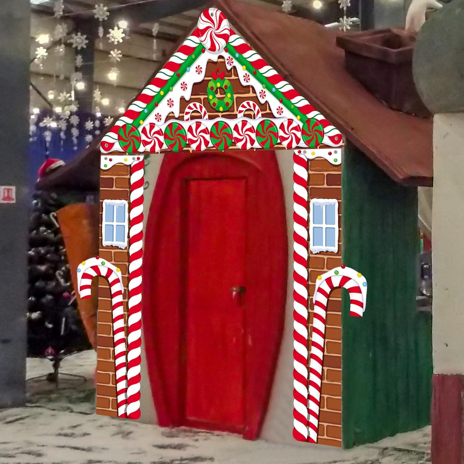 Gingerbread house themed Christmas porch banner with candy cane accents and a red door.
