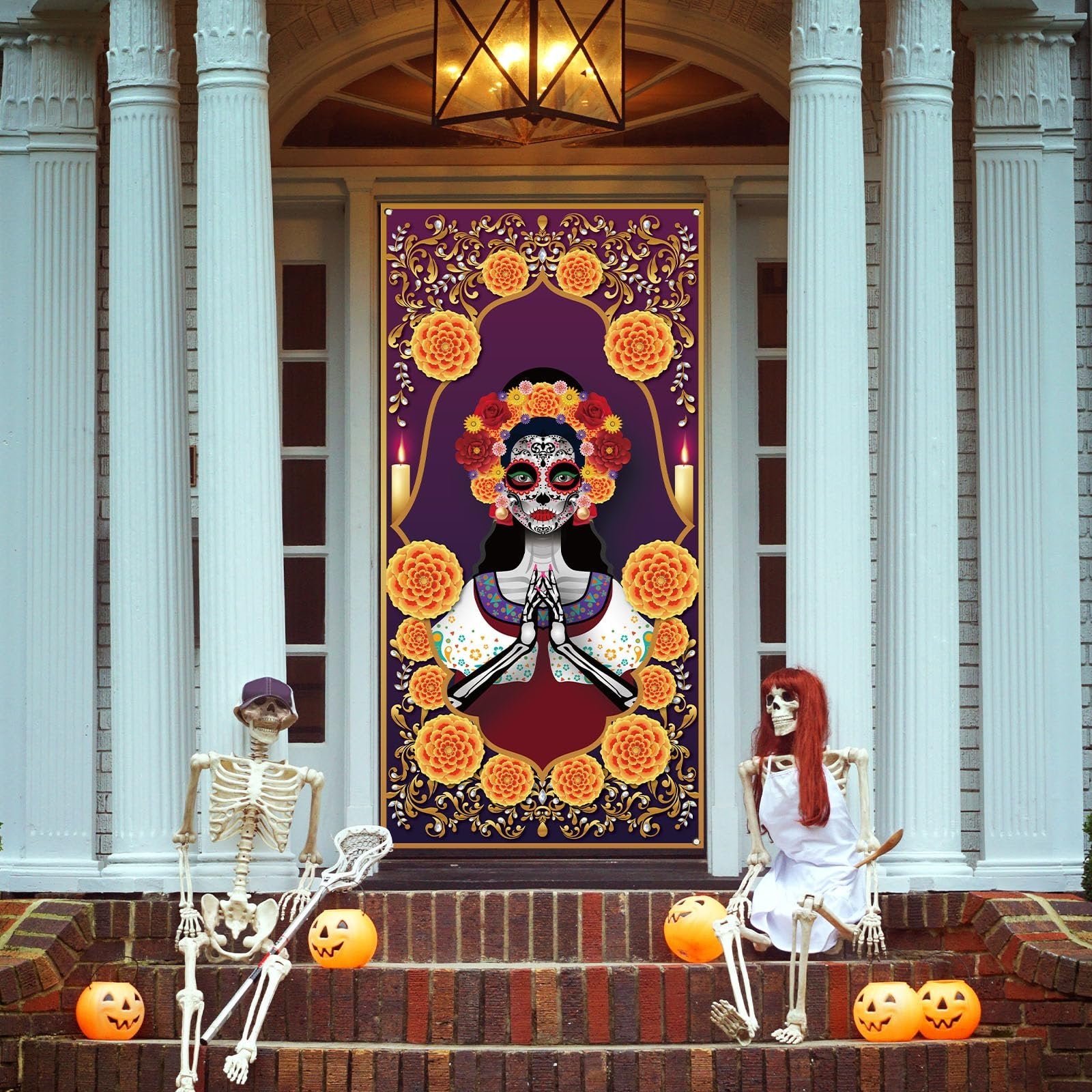 Day of the Dead door cover with sugar skull and marigolds, displayed on a front door with skeletons and pumpkins on the steps.