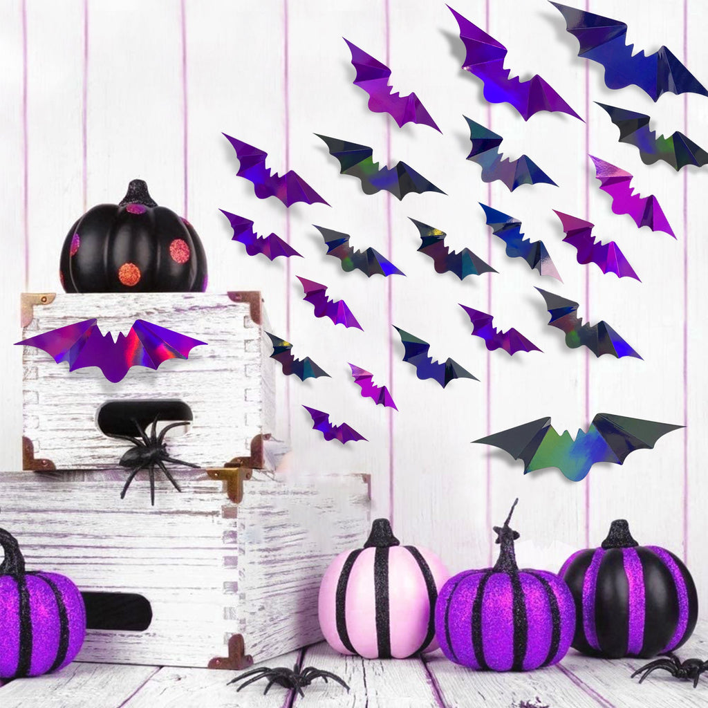 Iridescent 3D bat wall decals in various sizes arranged on a white wooden wall with decorative pumpkins and spiders below.