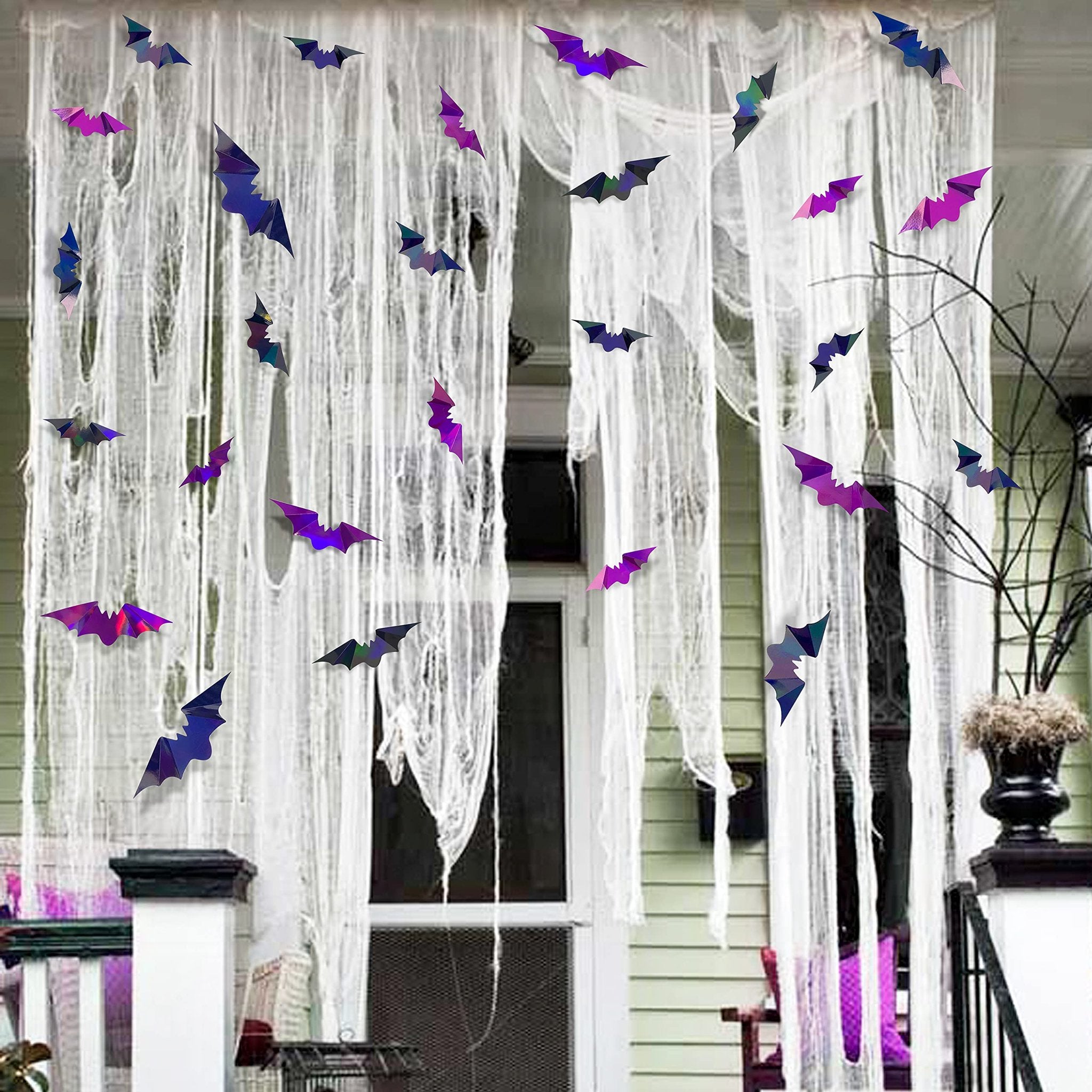 Iridescent 3D bat wall decals decorating a porch with white tattered fabric for Halloween