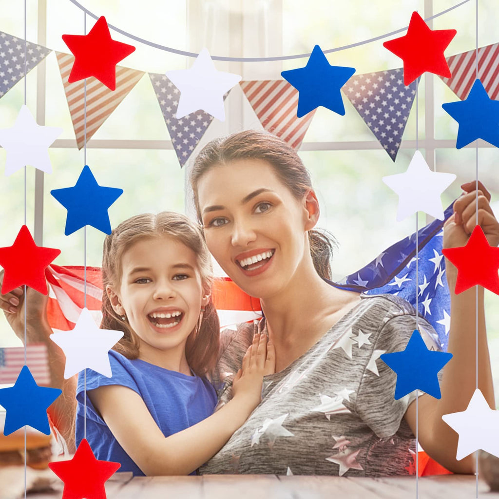 Mother and daughter celebrating with red, white, and blue star decorations and an American flag.