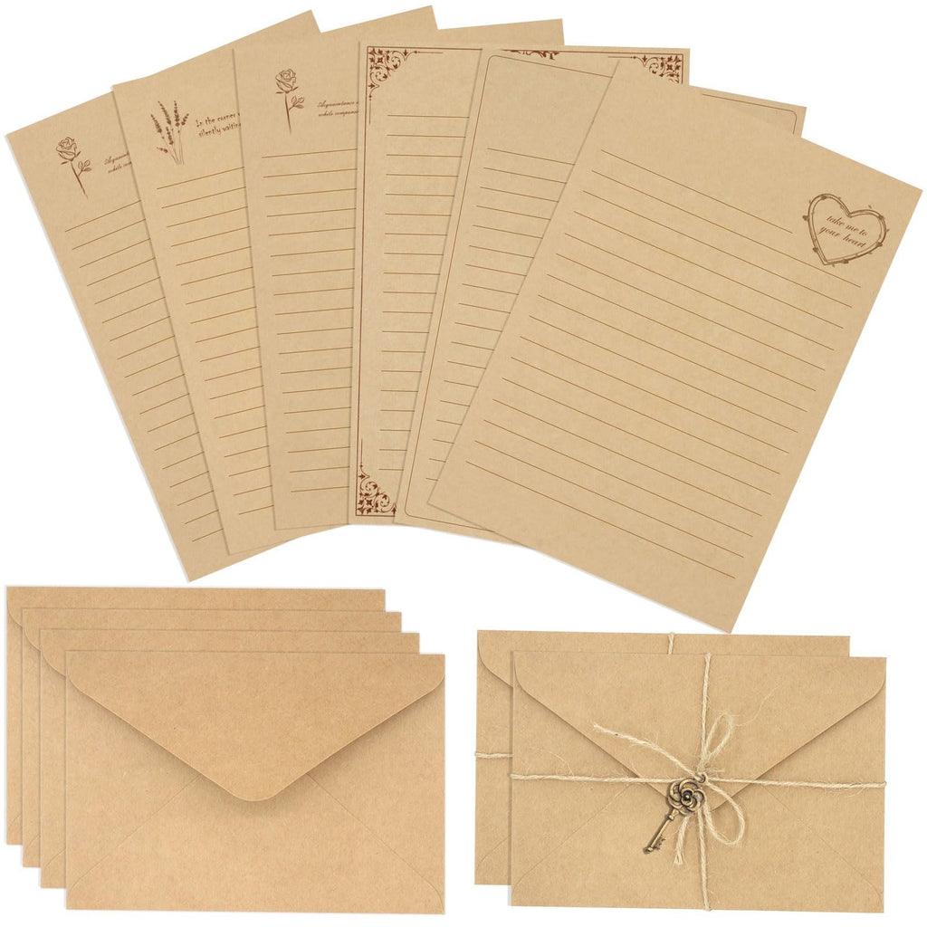 Vintage stationery set with lined kraft writing paper, envelopes, and decorative keys. Top view.