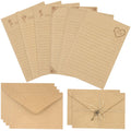 Vintage stationery set with lined kraft writing paper, envelopes, and decorative keys. Top view.