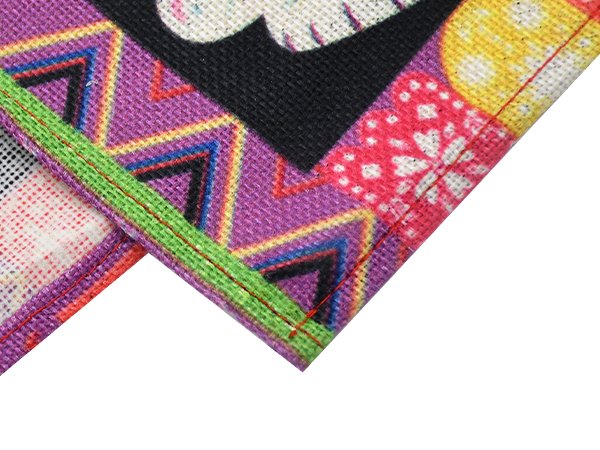 Close-up of a colorful Day of the Dead table runner with sugar skull print and zigzag patterns.