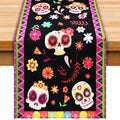 Day of the Dead themed table runner with sugar skull and floral print, displayed on a wooden table.