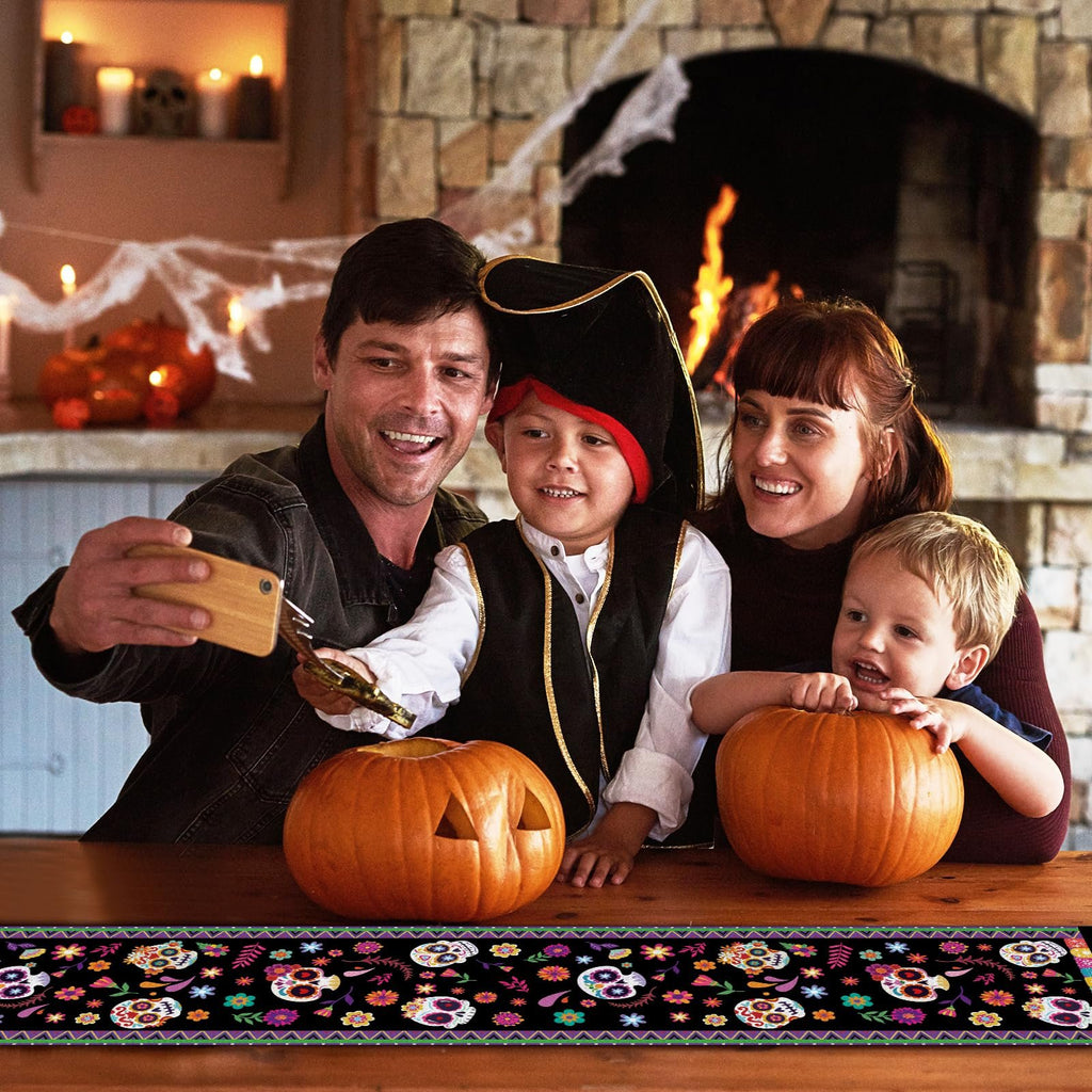 Family taking a selfie with pumpkins and a Halloween-themed table runner