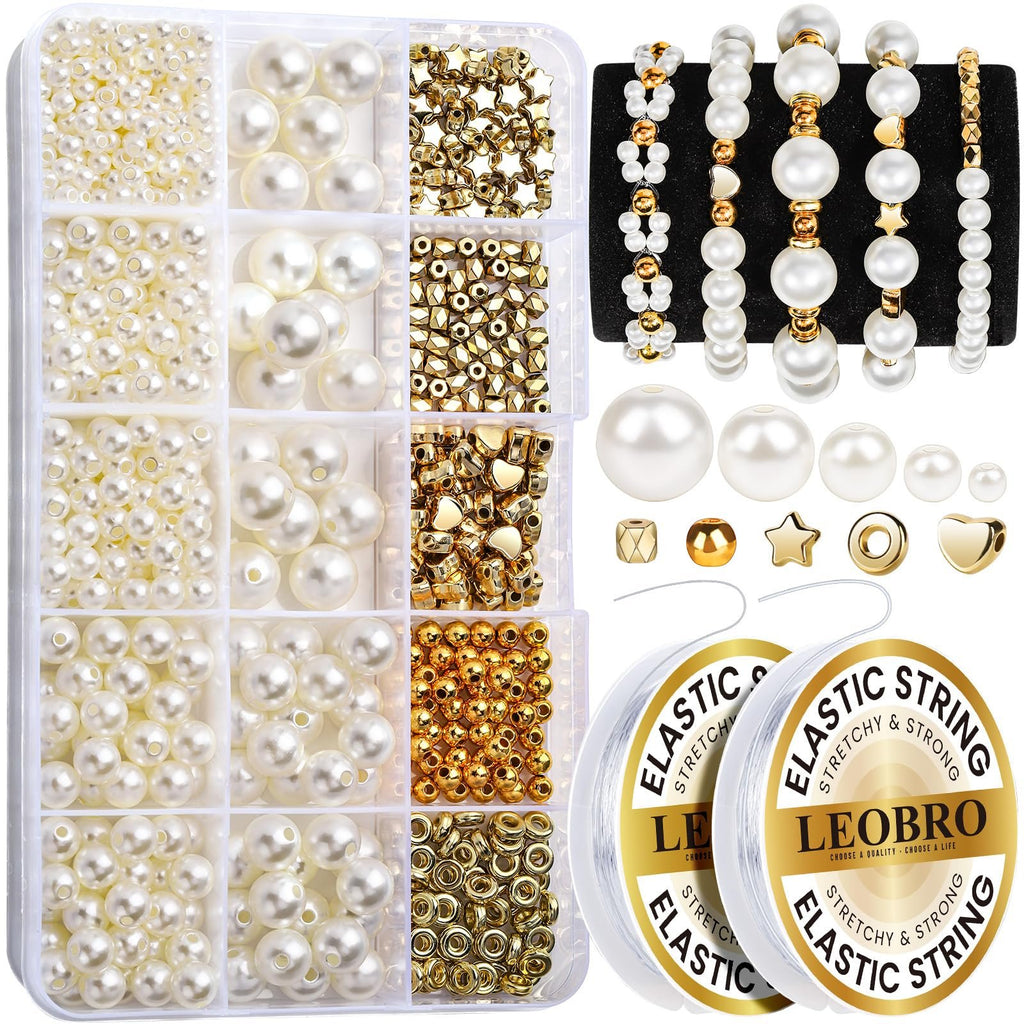 Pearl and gold bead bracelet making kit with assorted beads, charms, and elastic string on spools.