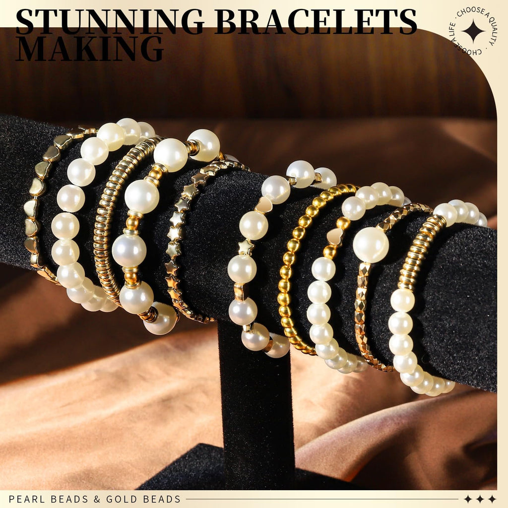 Assortment of pearl and gold beaded bracelets displayed on a black velvet stand.