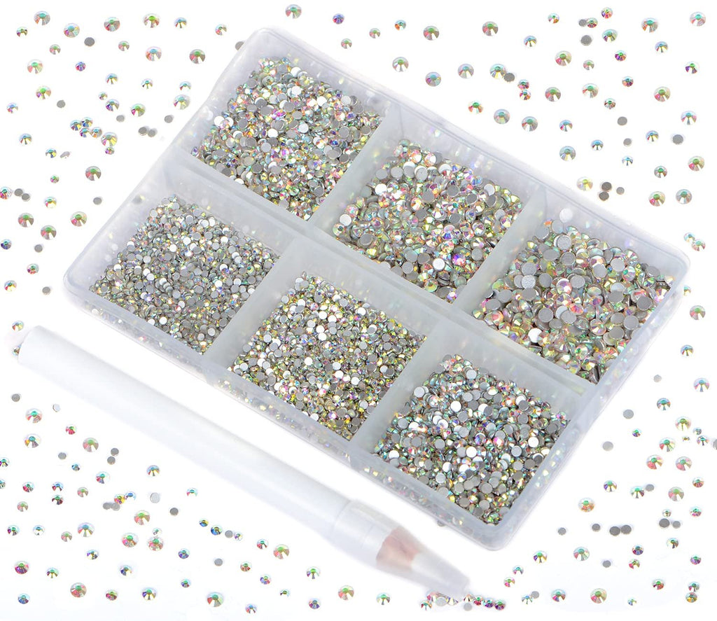 Set of crystal AB glass flatback rhinestones in a divided container with a picking pen, scattered rhinestones around the container.