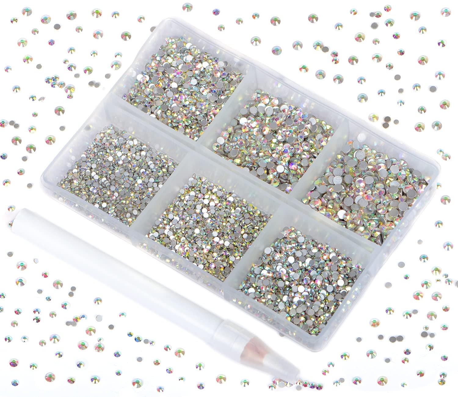 Set of crystal AB glass flatback rhinestones in a divided container with a picking pen, scattered rhinestones around the container.