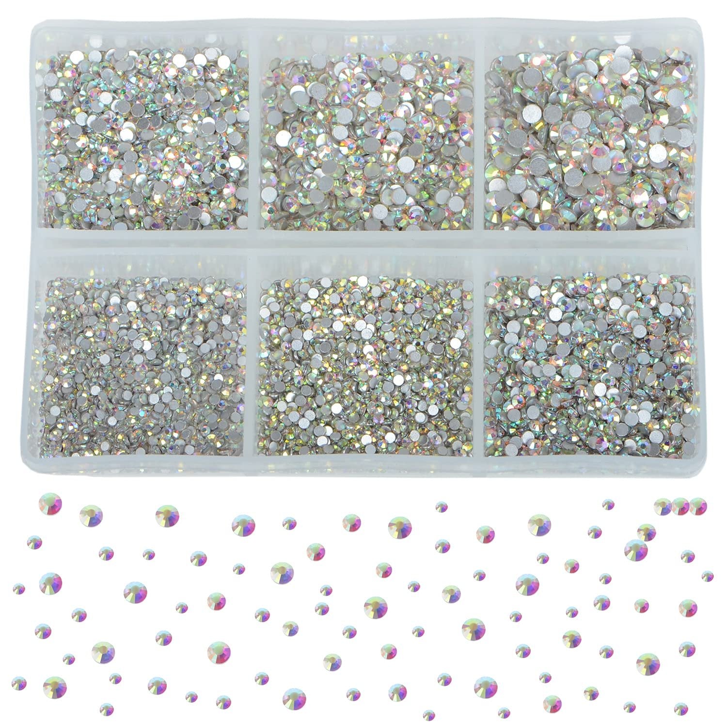 Crystal AB glass rhinestones in six compartments of a plastic organizer tray, with scattered rhinestones below