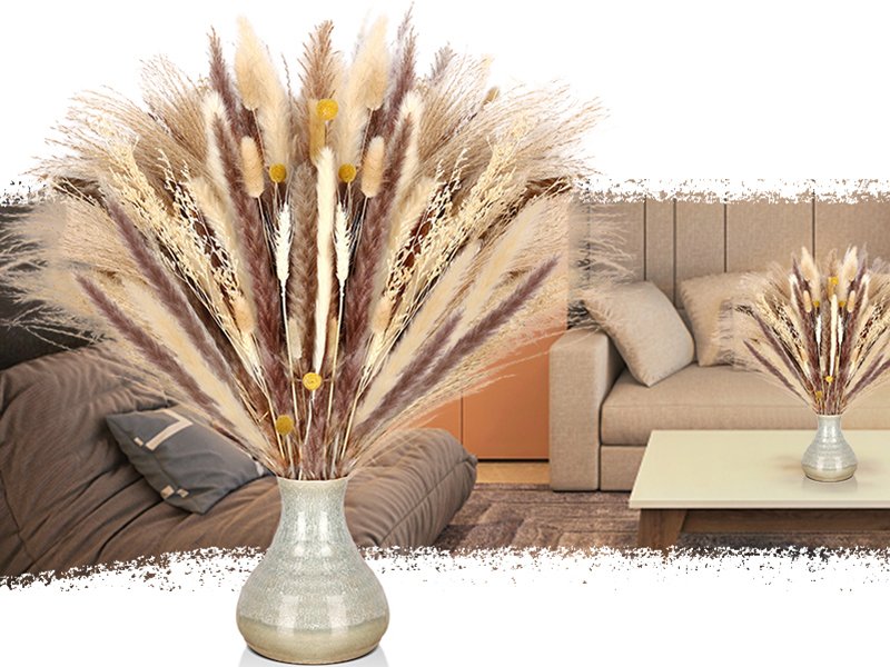 Dried pampas grass arrangement in a vase on a coffee table with a sofa in the background.