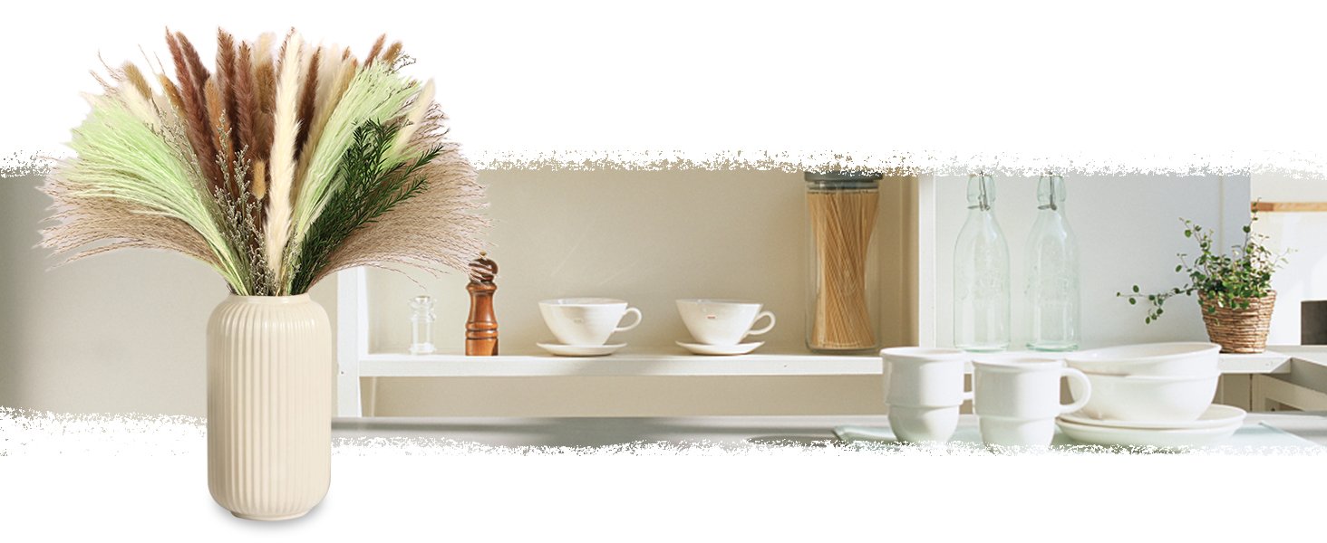 A vase filled with a variety of dried pampas grass in white, brown, and green hues, displayed on a shelf with kitchenware.