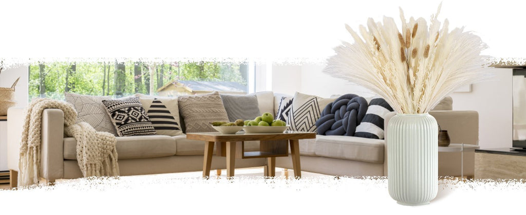 Dried pampas grass arrangement in a fluted vase on a coffee table in a living room setting