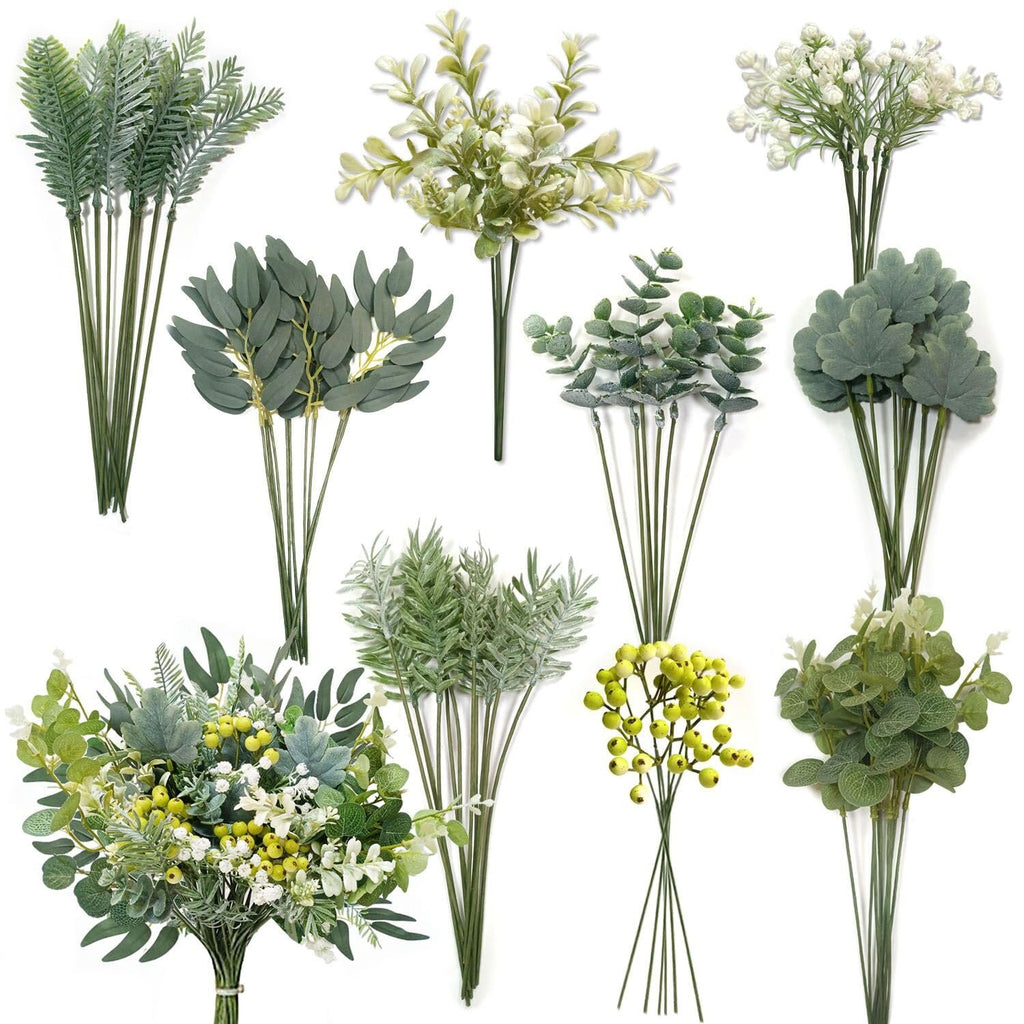 Assortment of artificial greenery stems including ferns, eucalyptus, and berry sprigs on white background