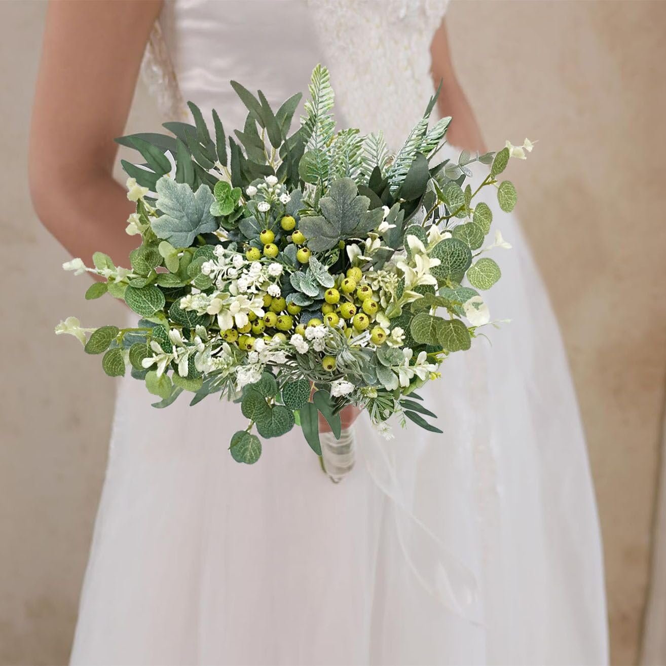 Bride holding a lush bouquet of artificial greenery with yellow berries and white flowers