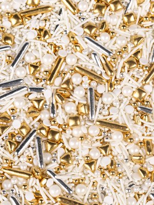 Close-up of gold, silver, and white edible sprinkles including pearls, rods, and stars for cake decorating.