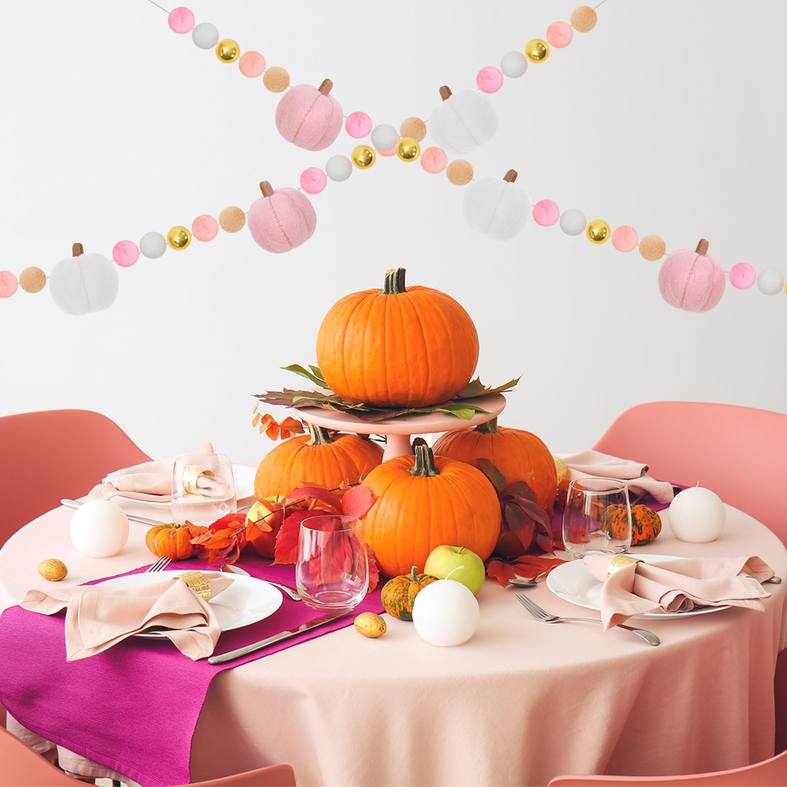 Fall table setting with pumpkins and a felt pumpkin garland hanging above