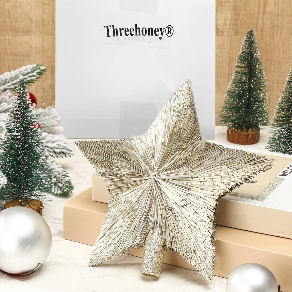 Champagne gold star tree topper with sisal-like texture, surrounded by mini Christmas trees and ornaments.