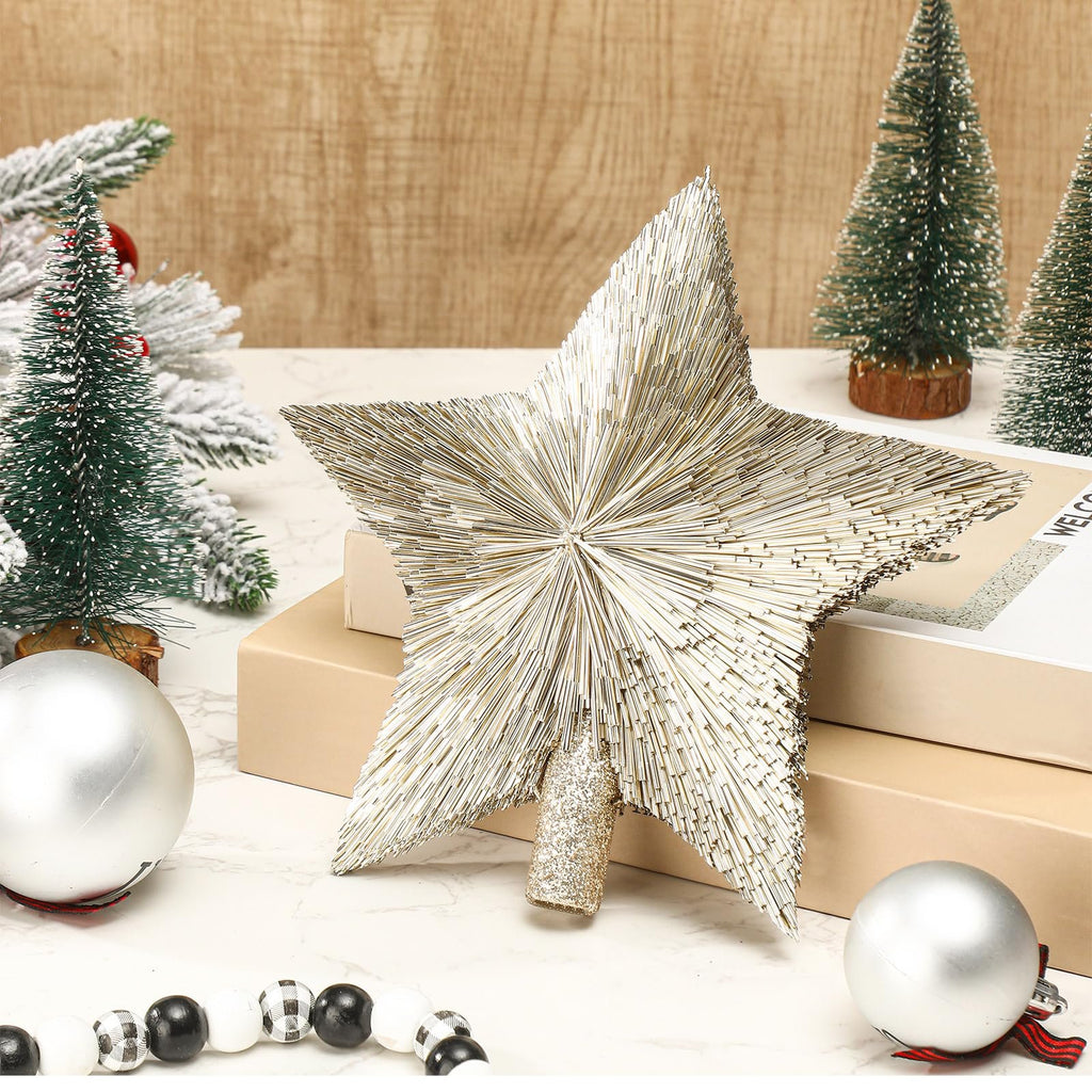 Champagne gold star tree topper with sisal-like texture, surrounded by miniature Christmas trees and ornaments.