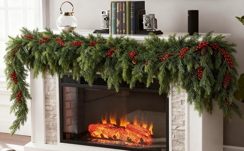 Christmas pine garland with red berries and pinecones draped over a fireplace mantel with an electric fire burning below.